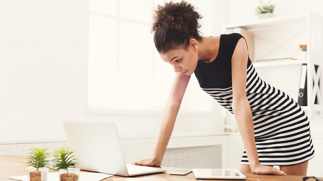 demo-attachment-115-business-woman-working-on-laptop-at-office-PRFJKQJ